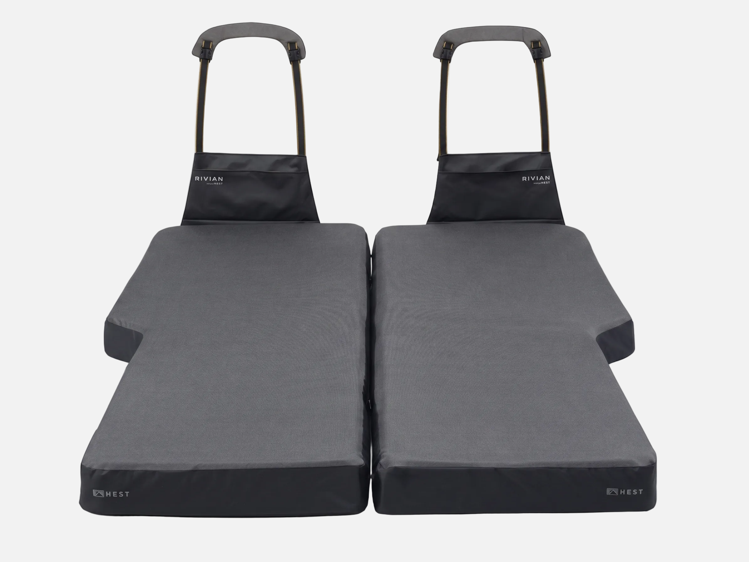 Two black folding mats with handles on a white background